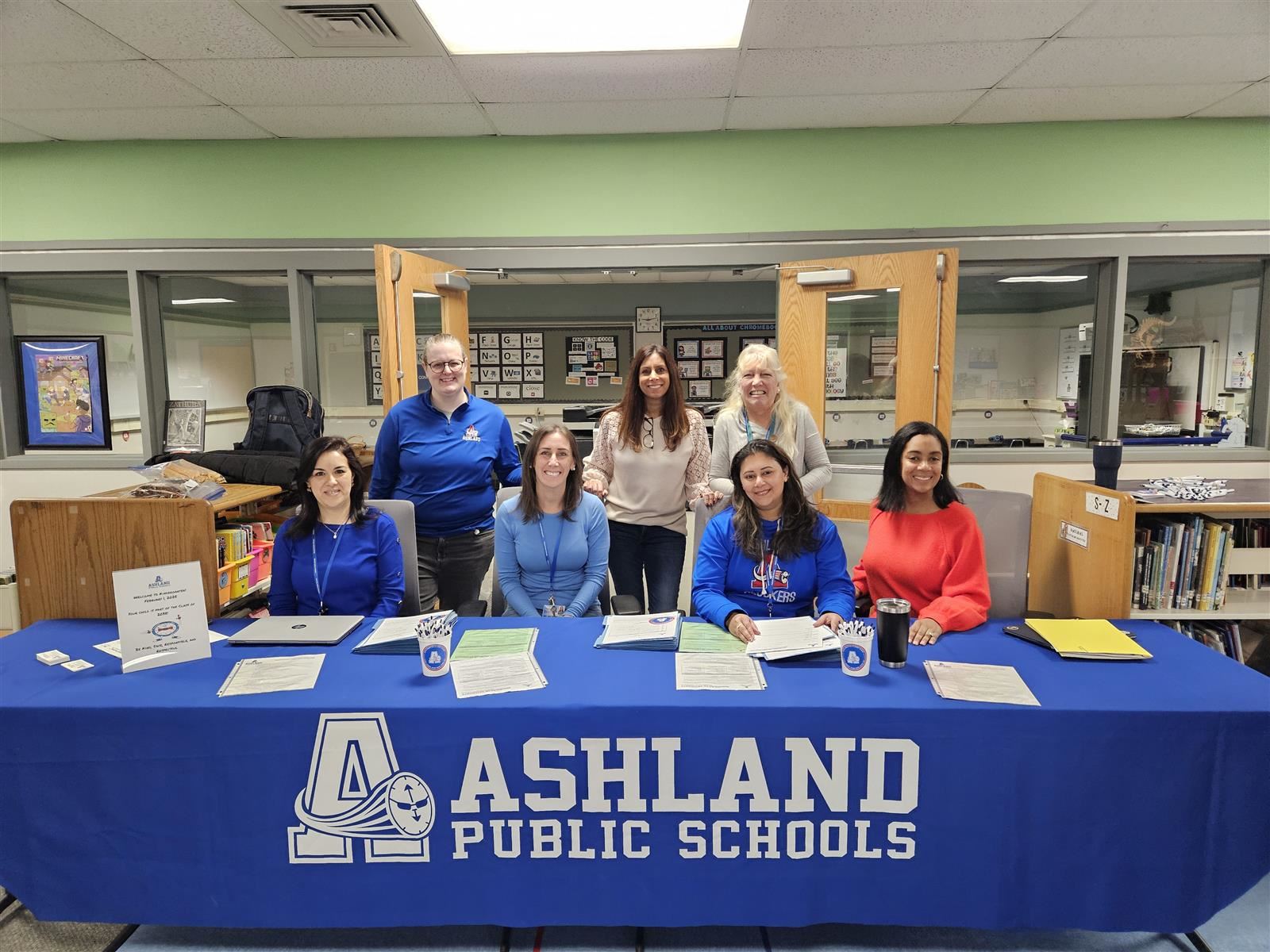 The Kindergarten Registration team sits at a table with a blue Ashland Public Schools tablecloth. The Kindergarten Registration team sits at a table with a blue Ashland Public Schools tablecloth.
